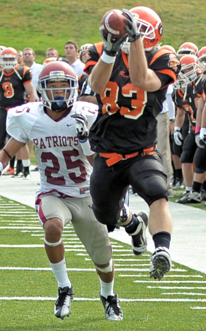 Chris Gohman makes a leaping catch in front of a University of the Cumberlands defender. Photo by Richard Davis