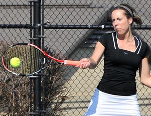 Haley Hart hits a return in a recent match. Monday she won in singles 6-0, 6-0. Photo by Richard Davis
